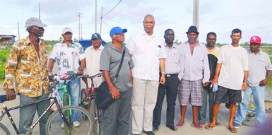 Minister in the Ministry of Finance, Juan Edghill with some of the farmers at Bush Lot