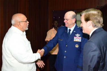 President Donald Ramotar (left) shakes hands with Florida National Guard, Major General Emmett Titshaw  while US Ambassador D Brent Hardt (right) looks on. (US Embassy photo) 