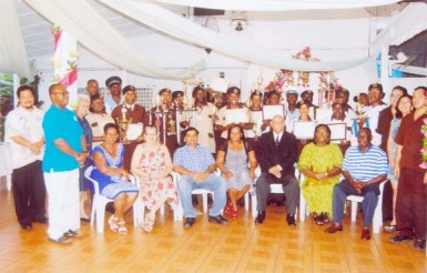 PGS staff and awardees display their certificates and awards at its Fourth Quarterly Presentation and Annual Awards on Saturday. PGS CEO Dougal Kirkpatrick is seated third from left. 