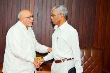 President Donald Ramotar (left) greeting Opposition Leader David Granger yesterday at the Office of the President. (GINA photo)