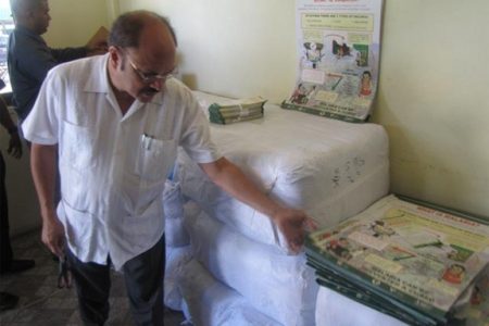 Health Minister Dr Bheri Ramsaran inspecting some of the educational material. (GINA photo)