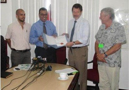Minister of Natural Resources and the Environment Robert Persaud (second from left) and German Ambassador Stefan Schluter with the note signed. (GINA photo)
