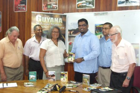 Acting Tourism Minister Irfaan Ali, publisher of the sixth edition of “Guyana Where and What,” Gem Madhoo-Nascimentos, acting THAG President Daniel Gajie, GTA Director Indranauth Haralsingh and other supporters at the launch of the tour guide. (Photo courtesy of the Tourism Ministry)