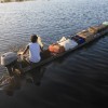 Nishal transporting beverages in his canoe for his mother’s shop