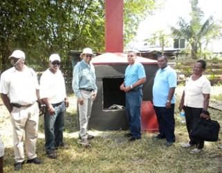 Minister of Natural Resources and the Environment Robert Persaud (third from left), Region Seven Chairman Gordon Bradford (third from right) and other officials in front of the new incinerator at Itaballi, Region Seven. (GINA photo)
