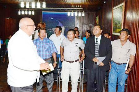 President Donald Ramotar (left) greets members of the Isseneru Village Council in company with the council’s lawyer David James (second from right). The Village’s captain Dennis Larson is third from left. (GINA photo)