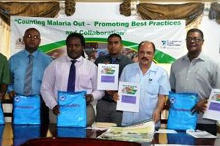 Minister of Health, Dr. Bheri Ramsaran (third from right) and representatives from the partnering organisations displaying the nets and accountability documents. (GINA photo)