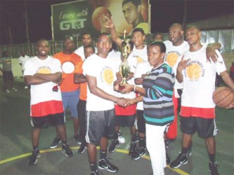 Ravens Basketball team receiving the winning trophy compliments of the Trophy Stall.