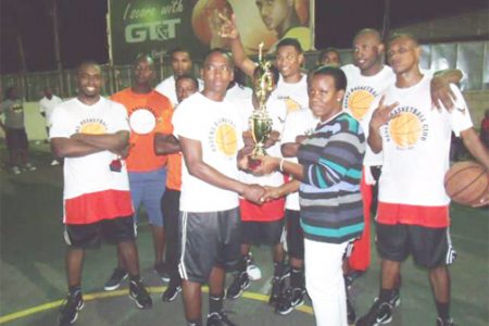 Ravens Basketball team receiving the winning trophy compliments of the Trophy Stall.