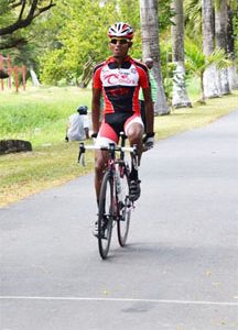Raynauth Jeffrey triumphantly crosses the finish line at yesterdays Ricks and Sari Agro Industries Limited11-race cycling meet at the National Park circuit, Thomas Lands.
