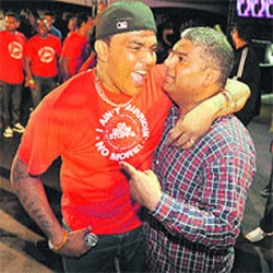 Newly-crowned Chutney Soca Monarch Raymond Ramnarine, left, celebrates with Attorney General Anand Ramlogan shortly after the results were announced at Skinner Park, San Fernando yesterday morning.