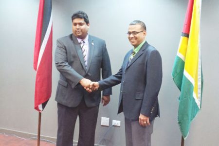 Minister Robert Persaud (right) greets his Trinidadian counterpart Kevin Ramnarine 