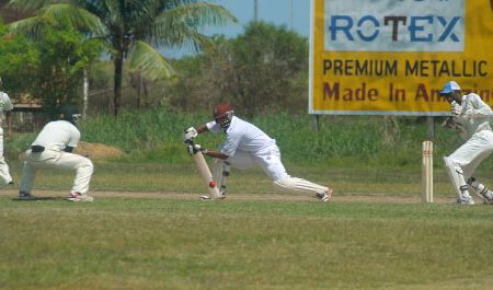 Middle order batsman Assad Fudadin stretches long forward during his innings yesterday. (Orlando Charles photo)
