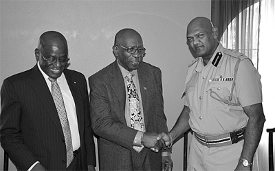 Minister of National Security Jack Warner, centre, congratulates new Chief Fire Officer Naya Rampersad. The outgoing Fire Chief Carl Williams is at left.  (Trinidad Guardian photo)