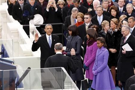 U.S. President Barack Obama (L) takes the oath from U.S. Supreme Court Justice John Roberts as his wife Michelle Obama and daughters Malia Obama (2nd R) and Sasha Obama (R) watch during swearing-in ceremonies on the West front of the U.S Capitol in Washington, January 21, 2013.
REUTERS/Kevin Lamarque