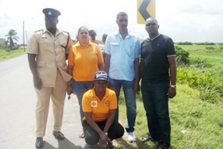 From left (standing) are Inspector in charge of D-Division Traffic, Jermaine Harper, Coordinator of the GNRSC Romona Doorgen, Chairman of the West Coast Demerara Road Safety Association Shahab Hack, Treasurer of the GNRSC Colvern Venture and a volunteer (stooping)