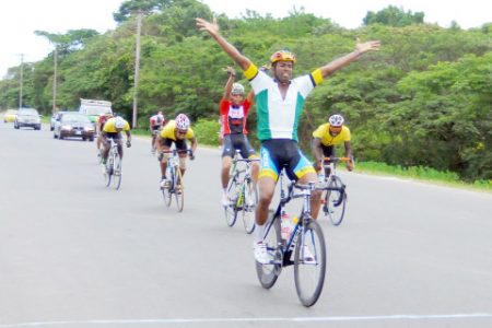 I DIT IT AGAIN! Warren `Forty’ Mc Kay of the Roraima Bikers Club, raises his hands aloft in triumph after winning yesterday’s National Sports Commission 40-mile road race on the West Coast of Demerara. (Orlando Charles photo)
