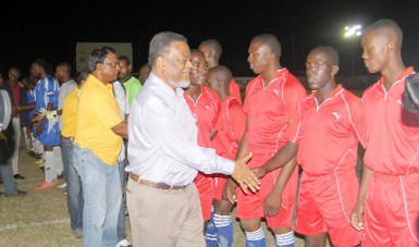 Prime Minister, Samuel Hinds and Managing Director of the National Milling Company (NAMILCO), Bert Sukhai greeting the teams following Sunday’s opening ceremony and march past. (Orlando Charles photo) 