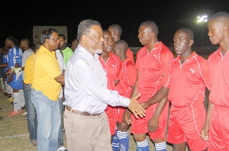 Prime Minister, Samuel Hinds and Managing Director of the National Milling Company (NAMILCO), Bert Sukhai greeting the teams following Sunday’s opening ceremony and march past. (Orlando Charles photo)