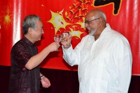Chinese Ambassador Zhang Limin (left) and President Donald Ramotar toast to celebrate the Chinese New Year. (GINA photo)
