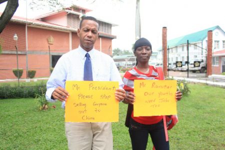 Activist Mark Benschop alongside Shonnette Adams during yesterday’s protest action. Benschop stated that the protest is an attempt to highlight unemployment, which he charged that the government does not seem to be serious about addressing.
