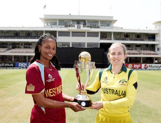 West Indies captain Merissa Aguilleira (left) Australia captain Jodie Fields pose with the trophy ahead of  today’s ICC Women’s World Cup Final. (Photo courtesy ICC tournament website) 