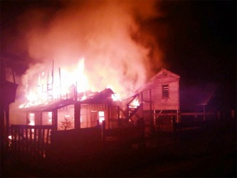 The Grove Housing Scheme house in flames before the arrival of fire-fighters. 