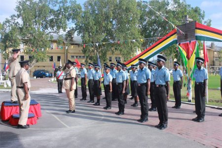 Acting Police Commissioner Leroy Brumell saluting officers at the passing out parade for Recruit Course No. 307 as well as participants at the closing of Disciplinary and Traffic seminars at the Felix Austin Police College on Thursday.  (Arian Browne photo)
