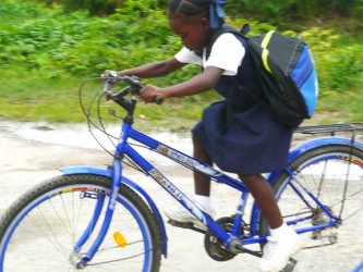 A young girl rides home during the lunch break