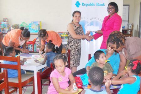Deborah Seebarran (left) Vice-Chairperson of the Step by Step Foundation accepting the sponsorship cheque from Michelle Johnson, Manager – Marketing and Communications, Republic Bank (Guyana) Limited. (Republic Bank photo)