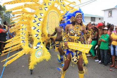 ‘Caribs’ on the march: One of the Ansa McAl floats making its way to the National Park on Saturday last. Ansa McAl took second place in the Full Costume Large Band category (Photo by Arian Browne)
