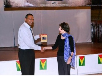 Author of ‘The Berbice Uprising 1763’, Anna Benjamin presenting Minister of Culture, Youth and Sport Dr Frank Anthony with a copy of her book. (GINA photo)