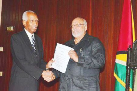 Justice Lensley Wolfe (left) handing over the report to President Donald Ramotar (GINA photo)
