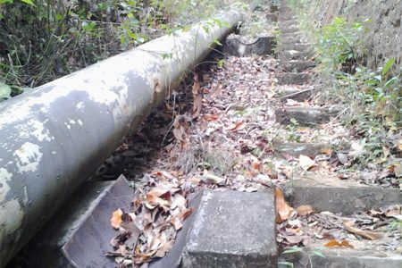 The landslide moved this steel pipe some distance away from the concrete structure where it once rested