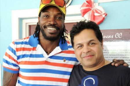 West Indies star Chris Gayle (left) shares the spotlight with managing director of Spartan Sports, Kunal Sharma, during a presentation at Lucas Cricket Club yesterday. (Jamaica Gleaner photo)