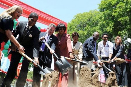 Prime Minister Portia Simpson Miller (fourth left) and a crew at work breaking ground for the cardiac wing of the Bustamante Hospital for Children yesterday. Other members of the team are (from left) Emma Scanlan, executive director, Chain of Hope; Lyttleton Shirley, chairman, South East Regional Health Authority; Andy Thorburn, chief executive officer, Digicel; Lady Allen; Fenton Ferguson, minister of health; artiste and philanthropist Orville 'Shaggy' Burrell. (Jamaica Gleaner photo) 