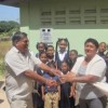 CDC Head, Chabilall Ramsarup (left) handing over the works to the headmistress.