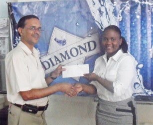 DDL Sales Manager Alexis Langhorne hands over the sponsorship cheque to Shiv Nandalall of the Guyana Chess Federation. 