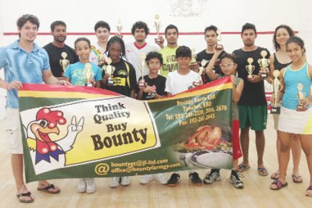 Winners and other outstanding performers of the 2013 Bounty Farm Mash Handicap Squash tournament pose with their accolades following the conclusion of the tournament at the Georgetown Club yesterday.