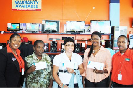 In the photo, Roslyn Mc Allister (second left), Susan Rahaman (centre) and Monette Cain (second from right) are holding their vouchers issued by Pegasus Hotel.  Looking on are Sharon Persaud, Store Manager - Robb Street (extreme left) and Wesley Cummings, Store Manager - Vreed-en-Hoop (extreme right).  Absent is Krishen Dyal Persaud.
