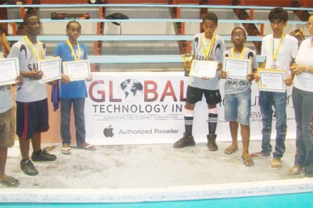 Members of the victorious St. Stanislaus College team receiving their gift certificates from sponsors Global Technology at last weekend’s Junior Hockey tournament at the National Gymnasium on Mandela Avenue.