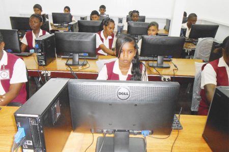 Fourth Form students of the Vryman’s Erven Secondary School in New Amsterdam, Berbice, using the new computer systems in their school’s renovated computer laboratory. The lab had been out of use for eight years before it was renovated last month and the new systems presented to the school by the Region Six Department of Education, through
funding from the Regional Democratic Council. (See story on page 15)