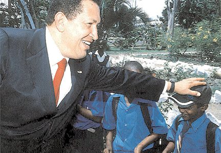 Flashback: Hugh Chavez greeting a schoolchild during his visit to Guyana on February 19, 2004. (Stabroek News file photo)

