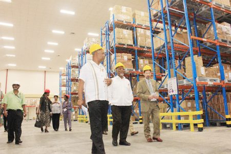 Prime Minister Samuel Hinds and Junior Minister of Finance Juan Edghill taking a tour of the Ministry of Health Supply Chain Management Complex that was commissioned yesterday. (Arian Browne photo)