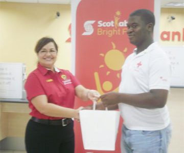 Scotiabank Country Manager Amanda St Aubyn (left) presents Collis Augustine with his iPad