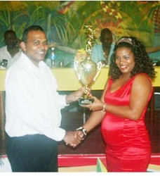Olympia Small Sonaram receives a trophy from Minister of Culture, Youth and Sport, Dr. Frank Anthony for Designer of the Year (GINA photo)