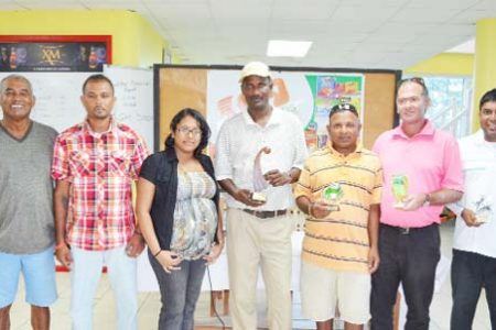 Winner Mohanlall “Santo” Dinnanauth  - (centre with cap) pose with other winners and officials of Carib Foods and LGC.