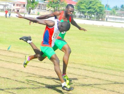 PIPPED! Olympian Winston George, left, pips South American Juniors bronze medallist Stephan James on the line in the final of the men’s Open 200m on Sunday at Camp Ayanganna. (Orlando Charles photo)