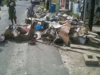 A pile of garbage appeared in Cowan Street after the flooding as residents threw out damaged items.
