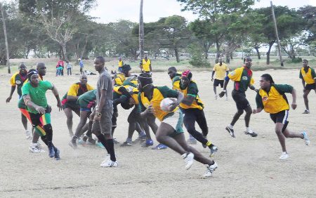 Action during the Guyana Rugby Football Union (GRFU) organized practice 15’s rugby games between players from South (yellow team) and North Georgetown (green team) on Saturday at the National Park Rugby field. (Orlando Charles photo)